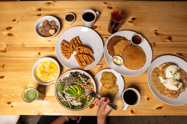 a bunch of food on a wooden table