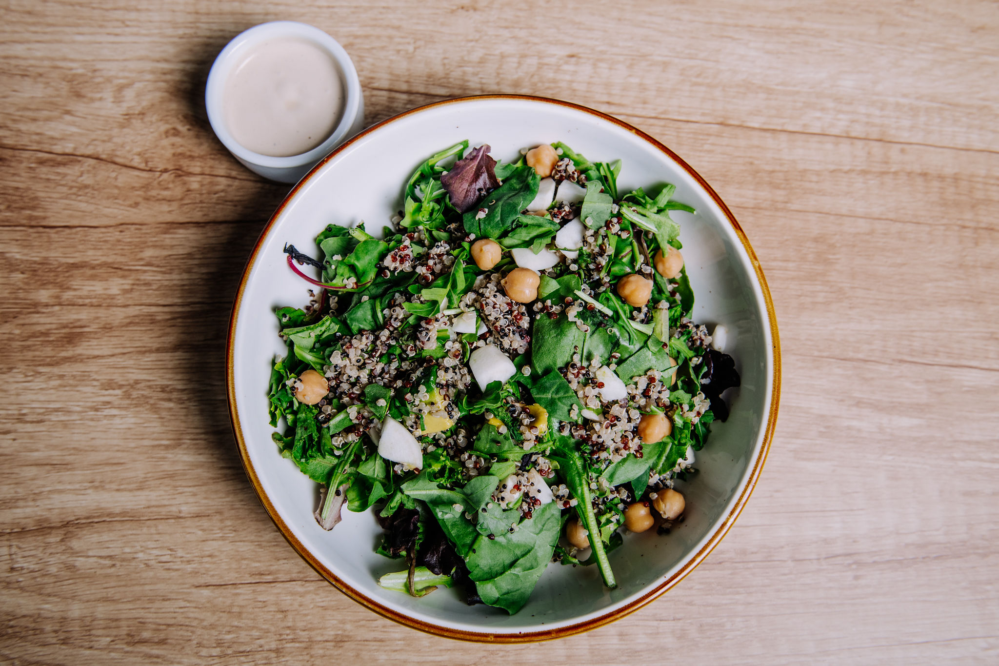a bowl of food sitting on top of a wooden table