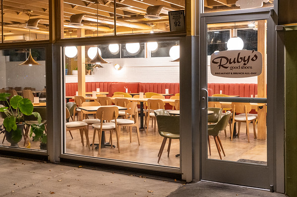 a group of people sitting at a table in a restaurant
