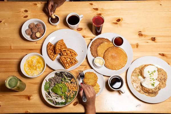a bunch of food sitting on a wooden table