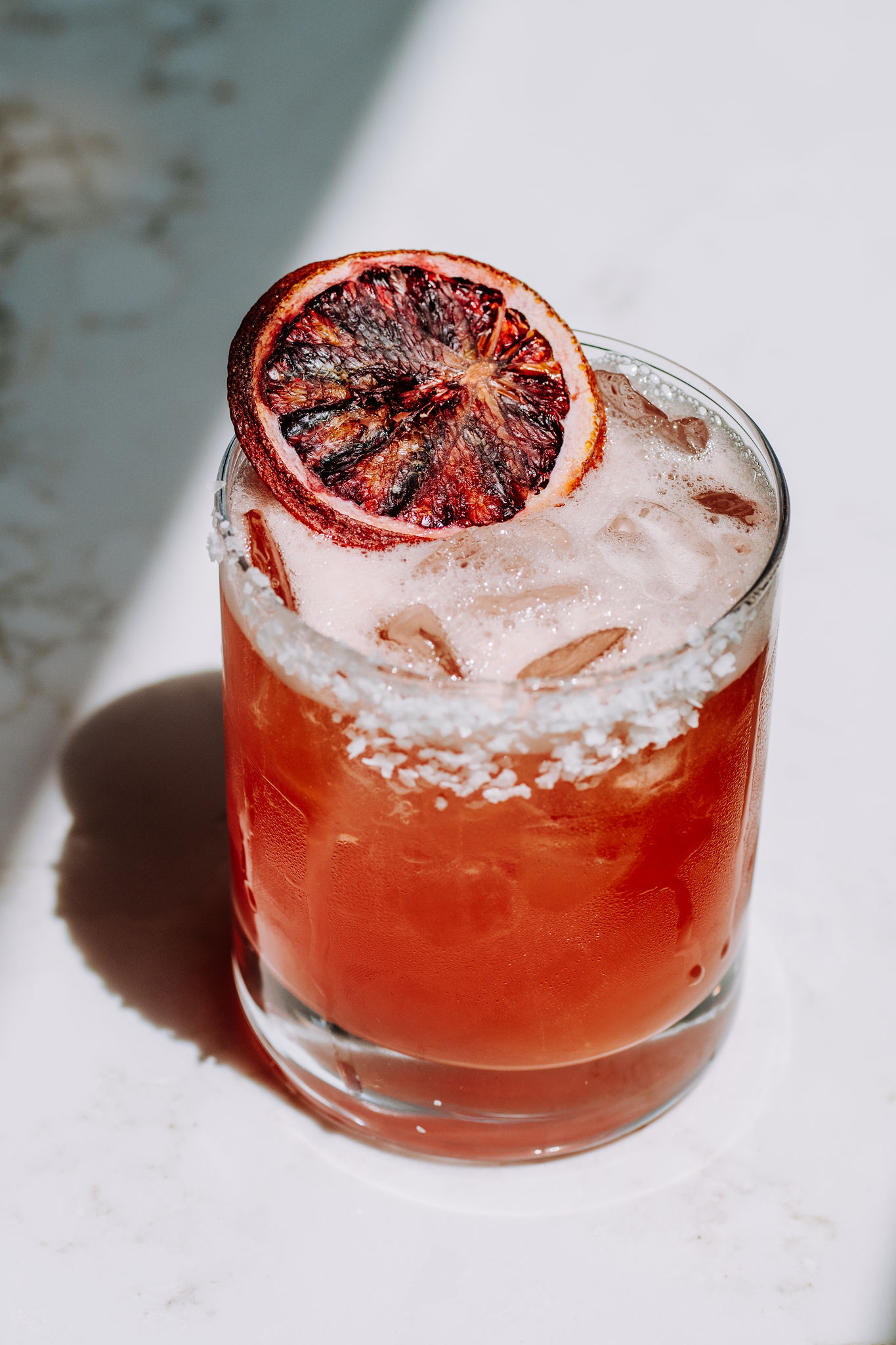 a glass of orange juice next to a cup of coffee