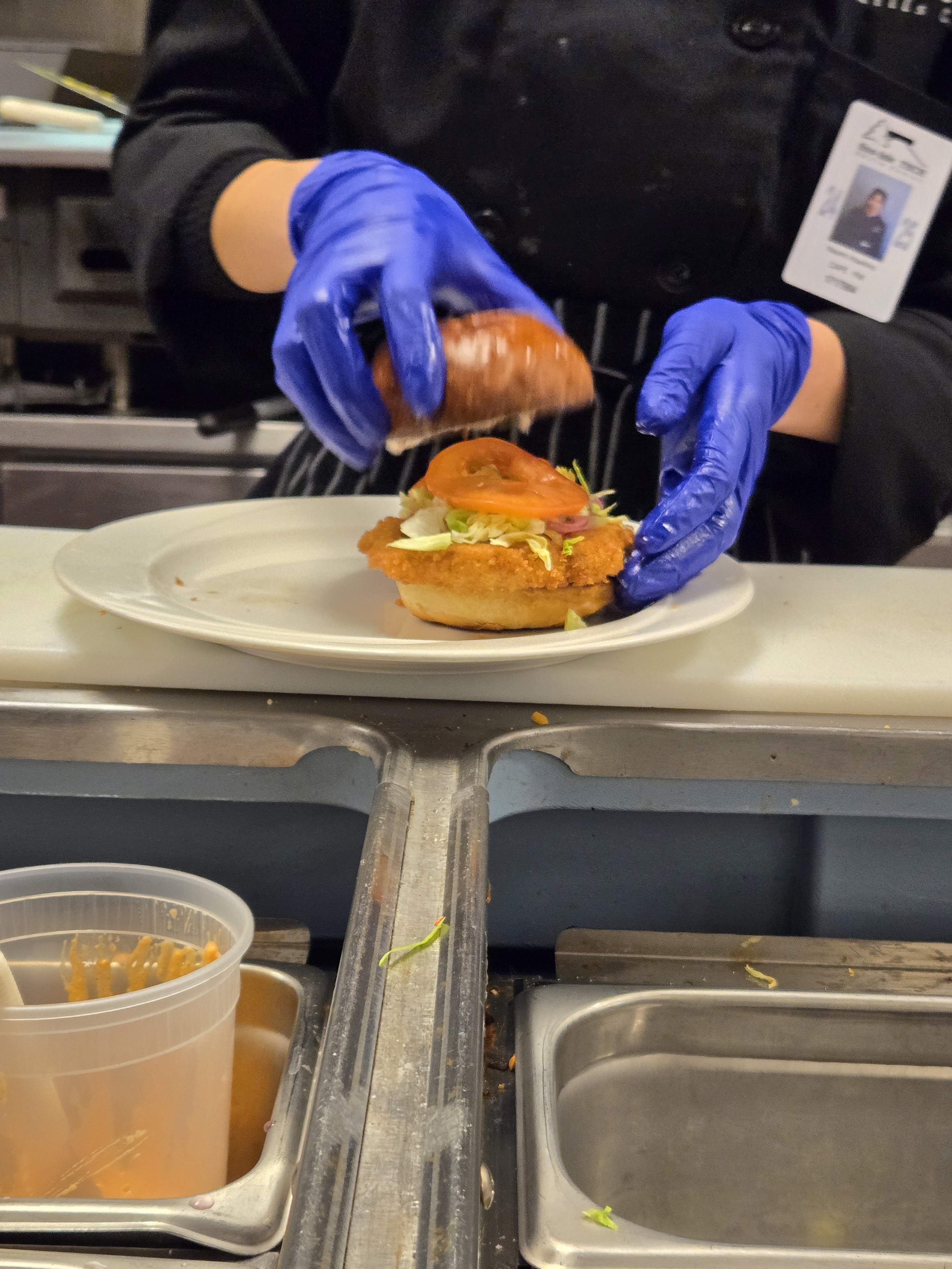 a person sitting at a table with a plate of food