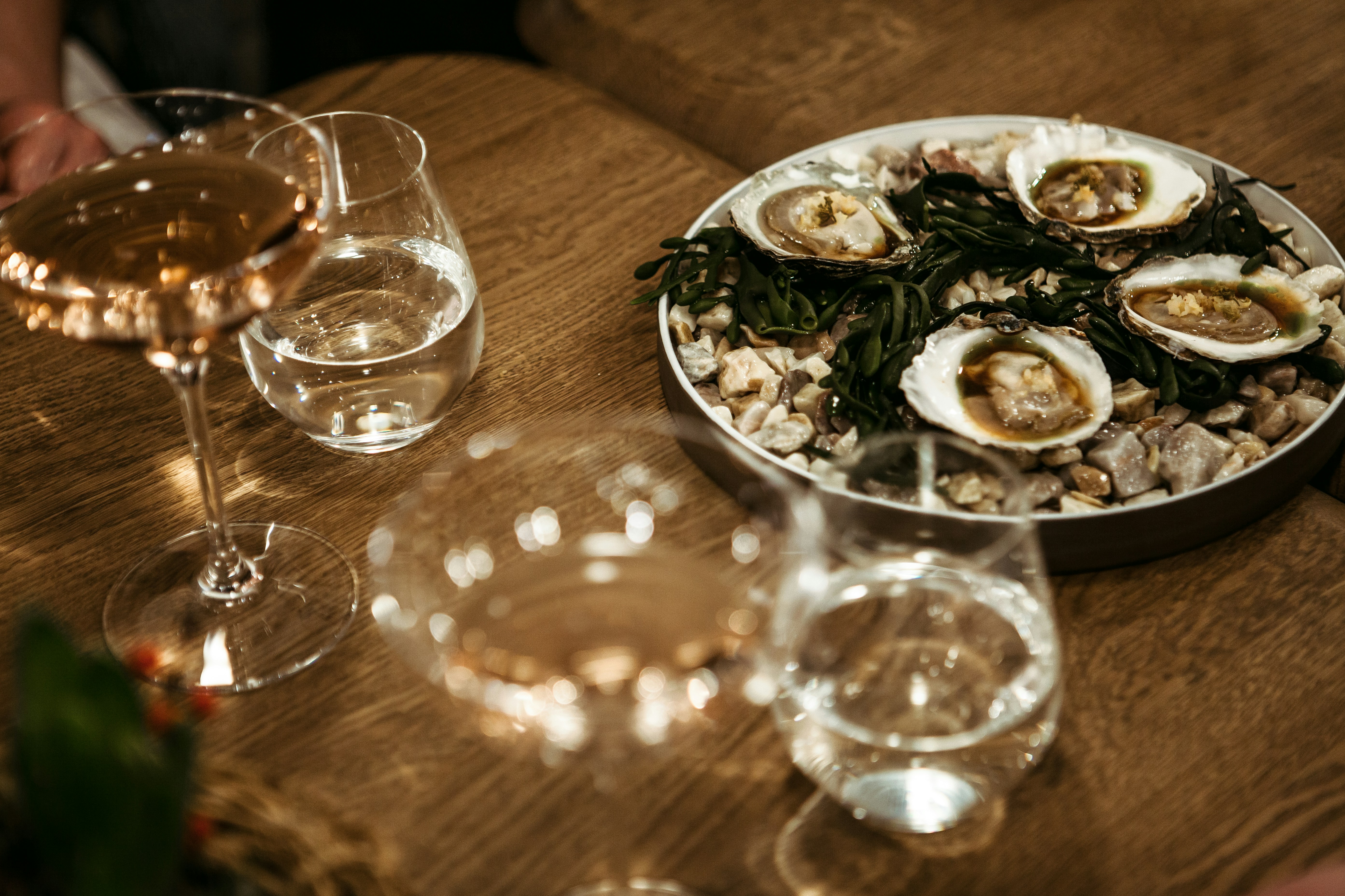 a group of people sitting at a table with wine glasses