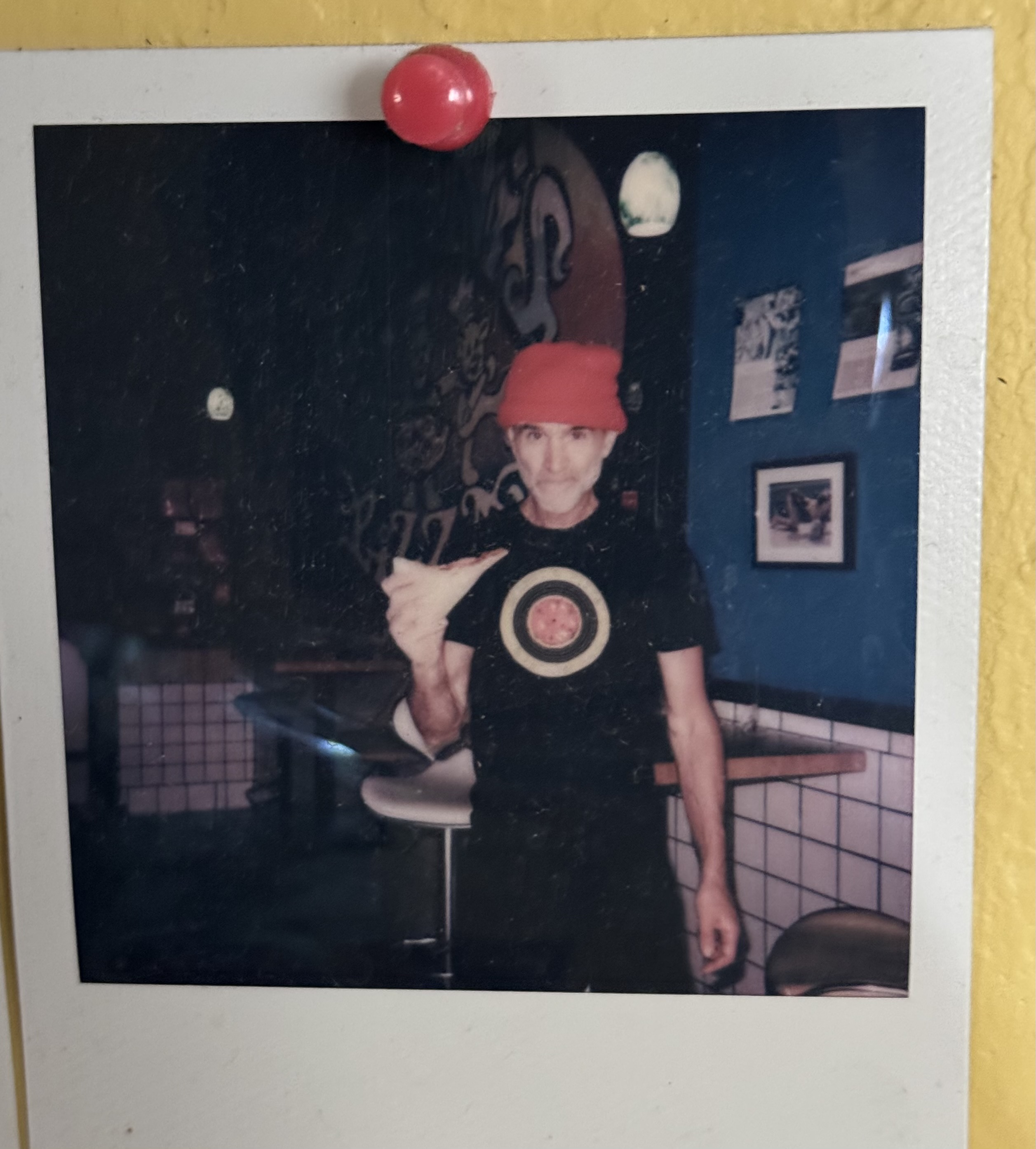 a man standing in front of a mirror posing for the camera