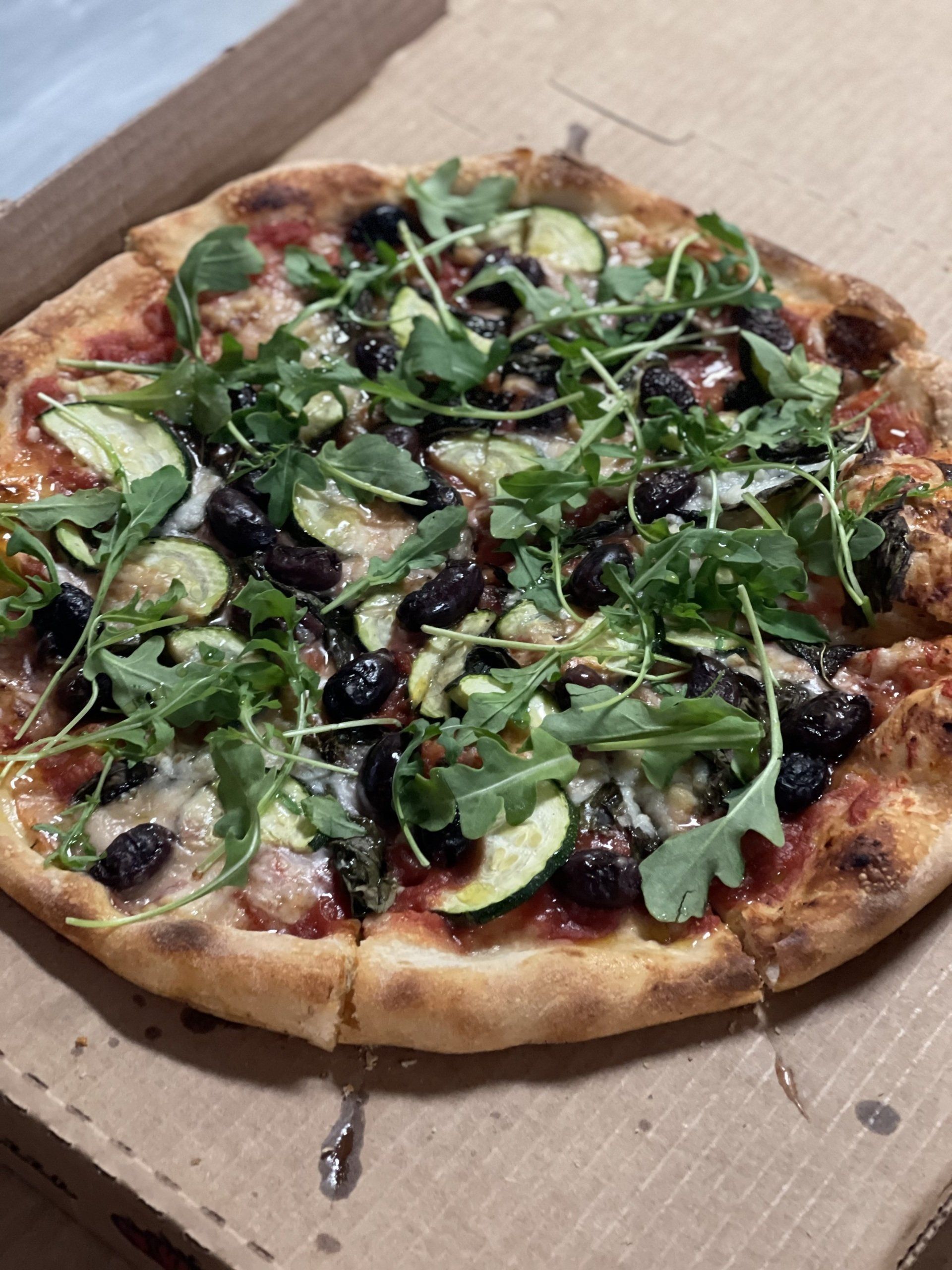 basil pizza with a thin crust