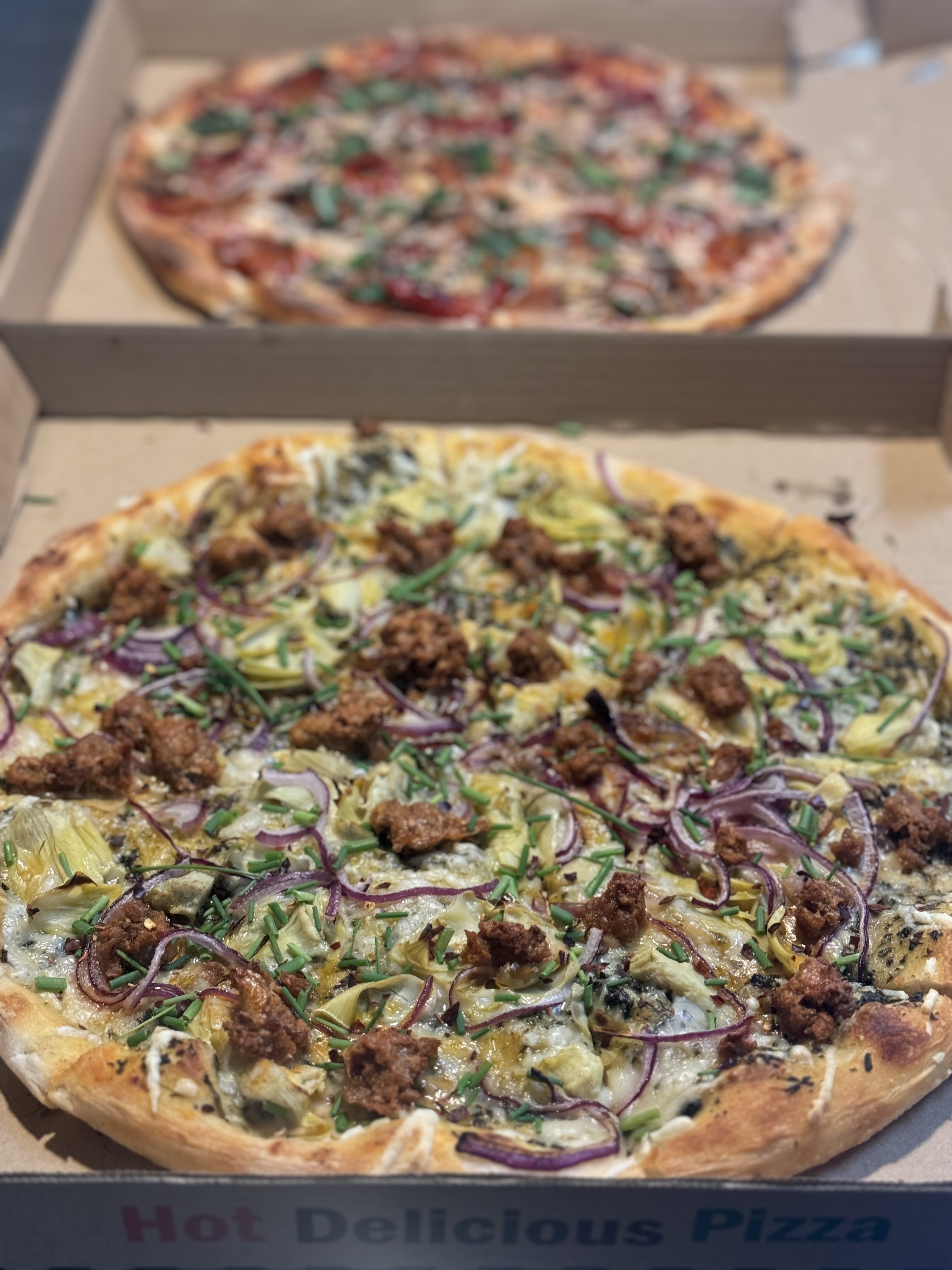 a pizza sitting on top of a box