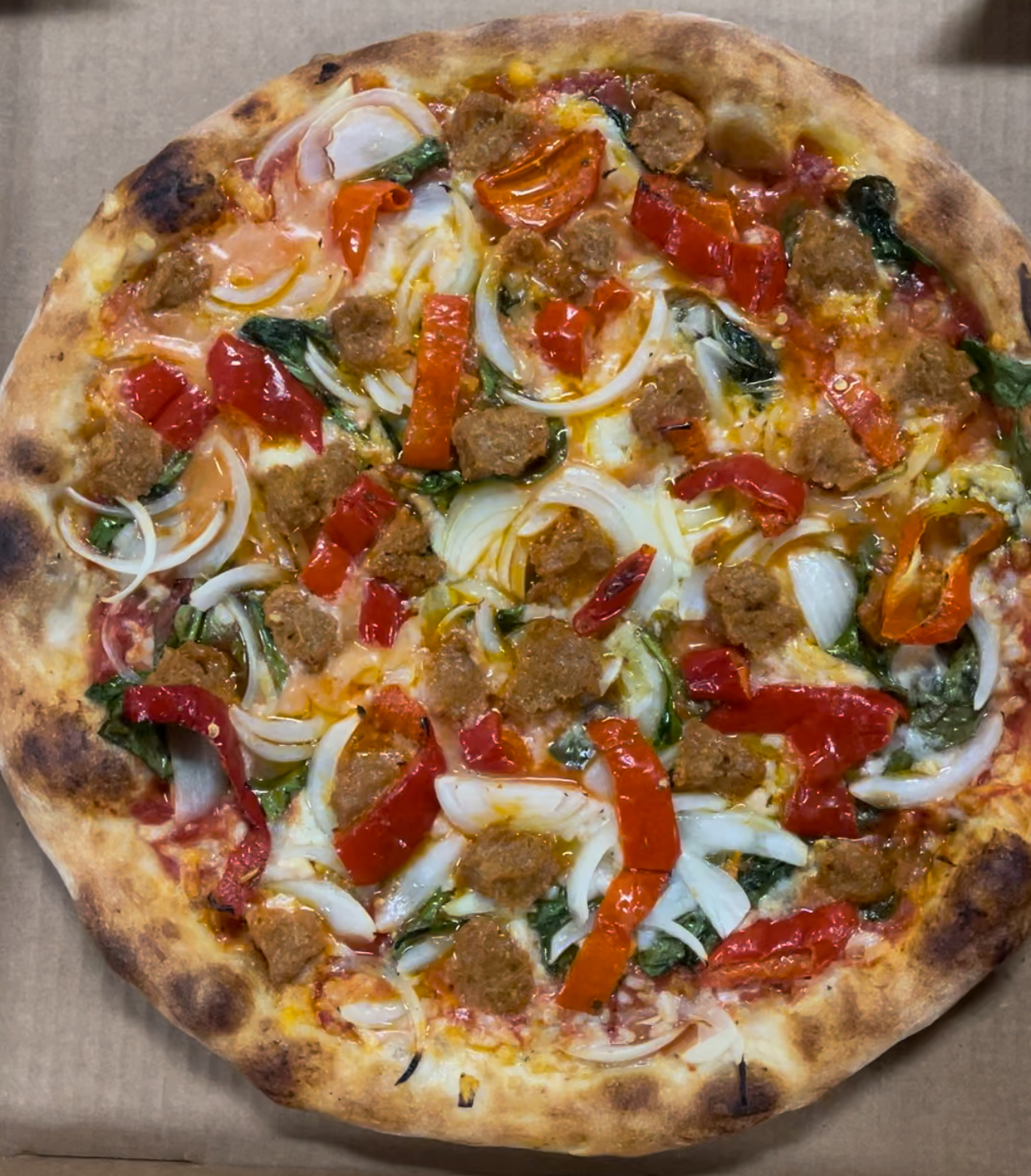 a pizza sitting on top of a wooden cutting board
