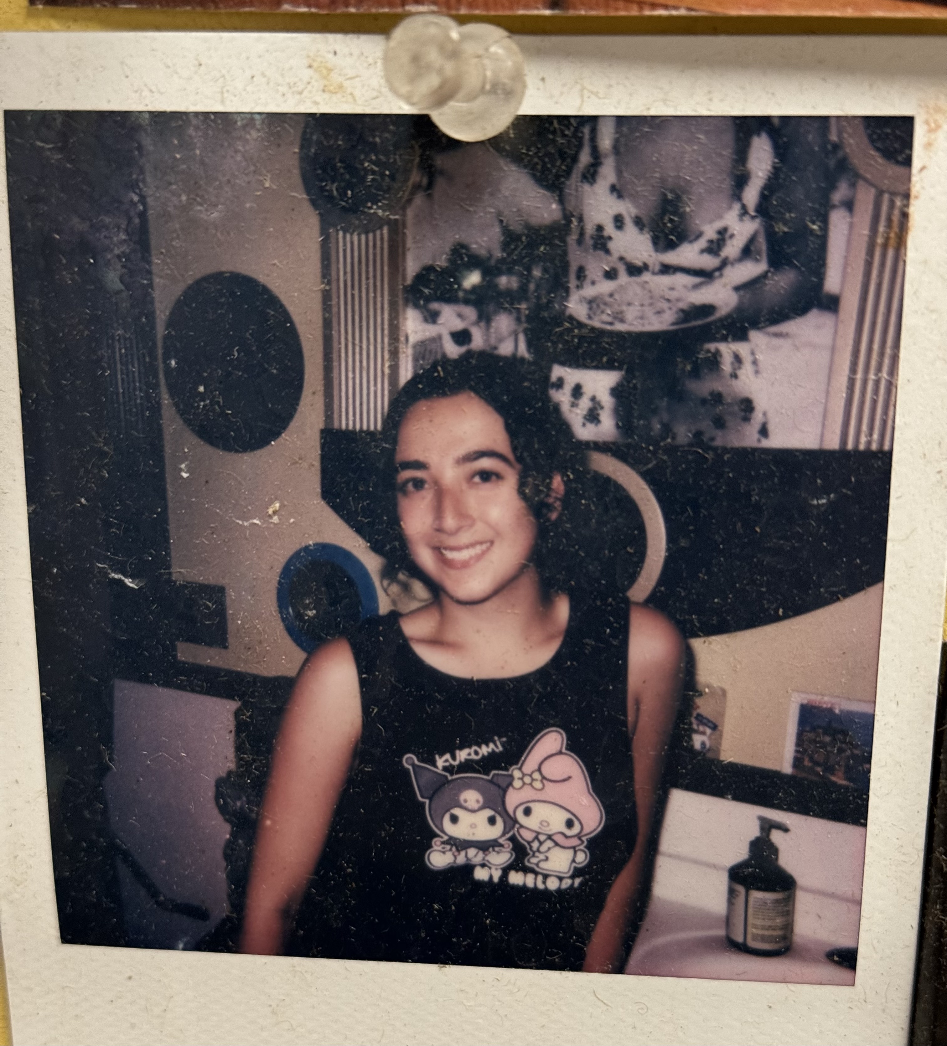 a woman standing in front of a mirror posing for the camera