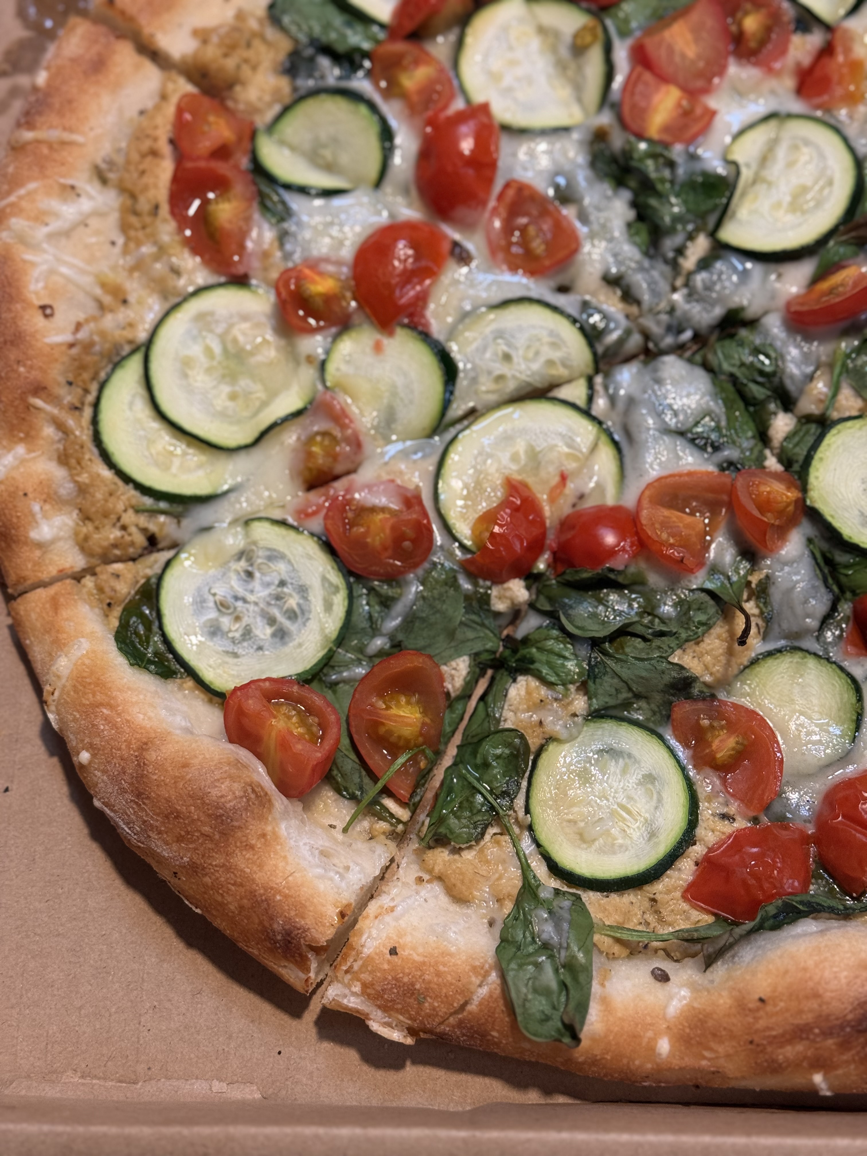 a pizza sitting on top of a cutting board