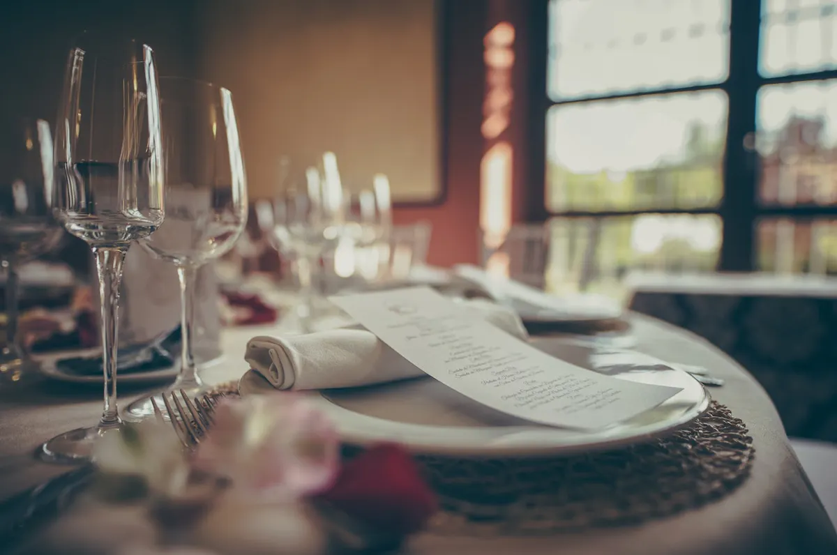 a close up of a wine glass sitting on a table