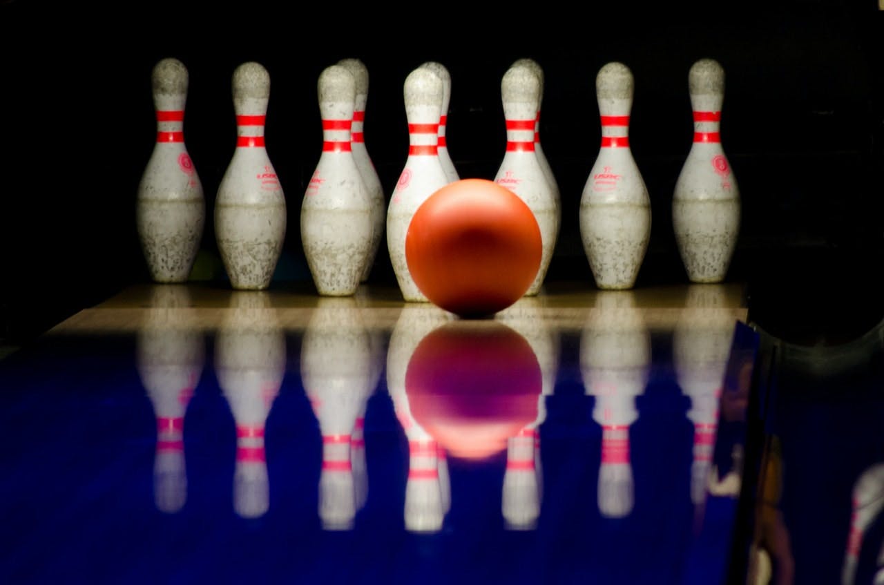 bowling ball hitting bowling pins