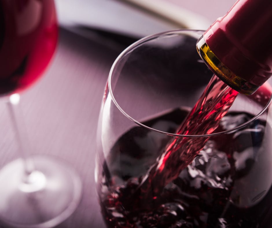 a close up of a glass of red wine