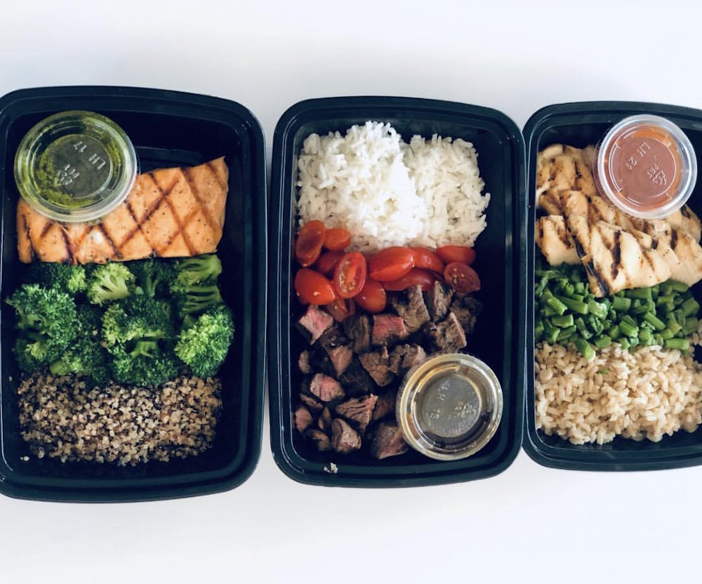 a plastic container filled with different types of food on a tray