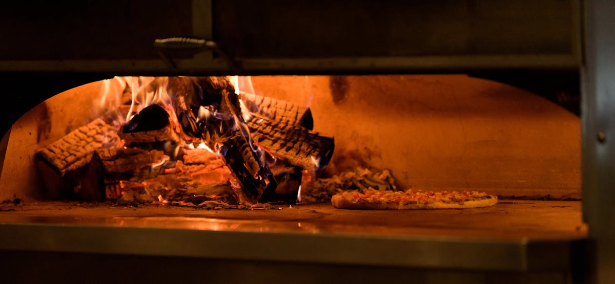 a stove top oven sitting next to a fireplace