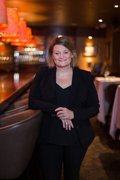 a woman standing in front of a table