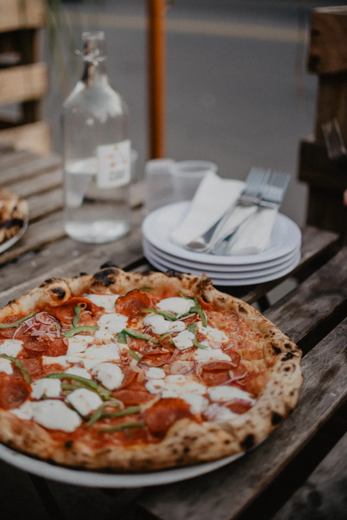 a pizza sitting on top of a wooden table