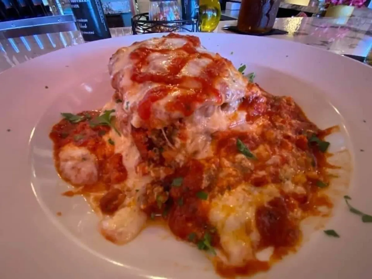 a plate of food with a slice of pizza