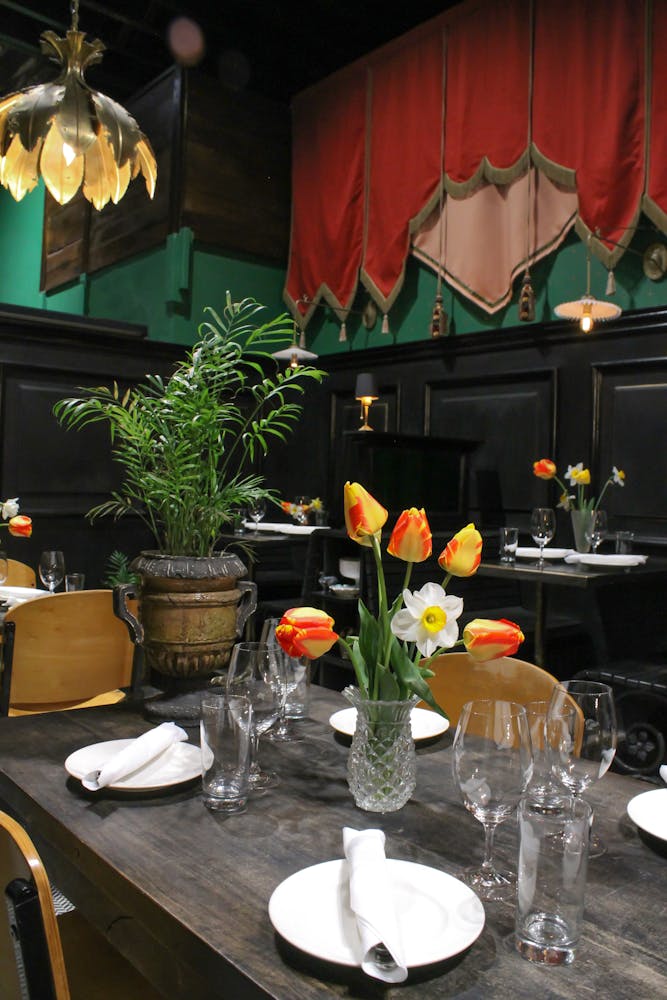 a vase of flowers on a table in dining room