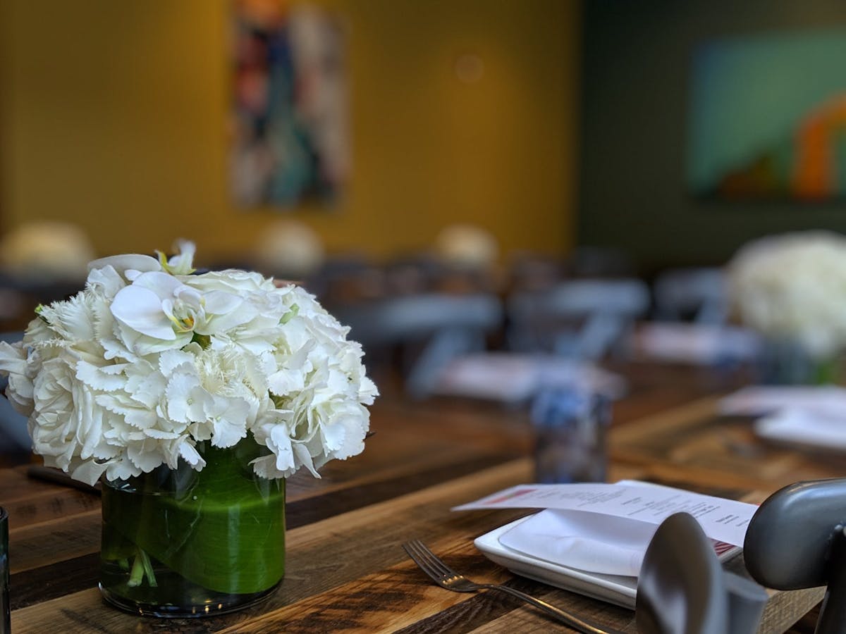 a close up of a vase of flowers on a table