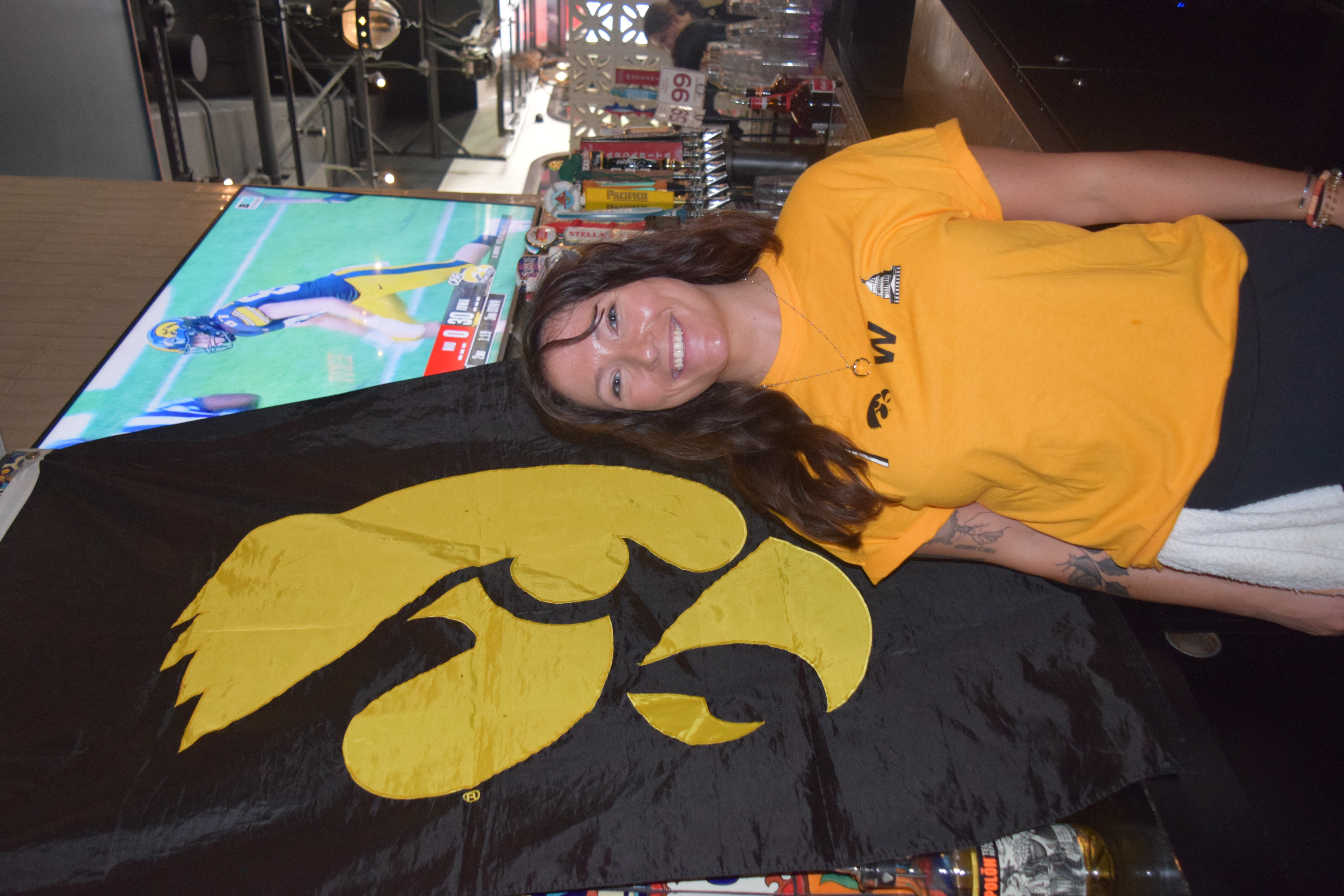 a woman standing in front of a flag
