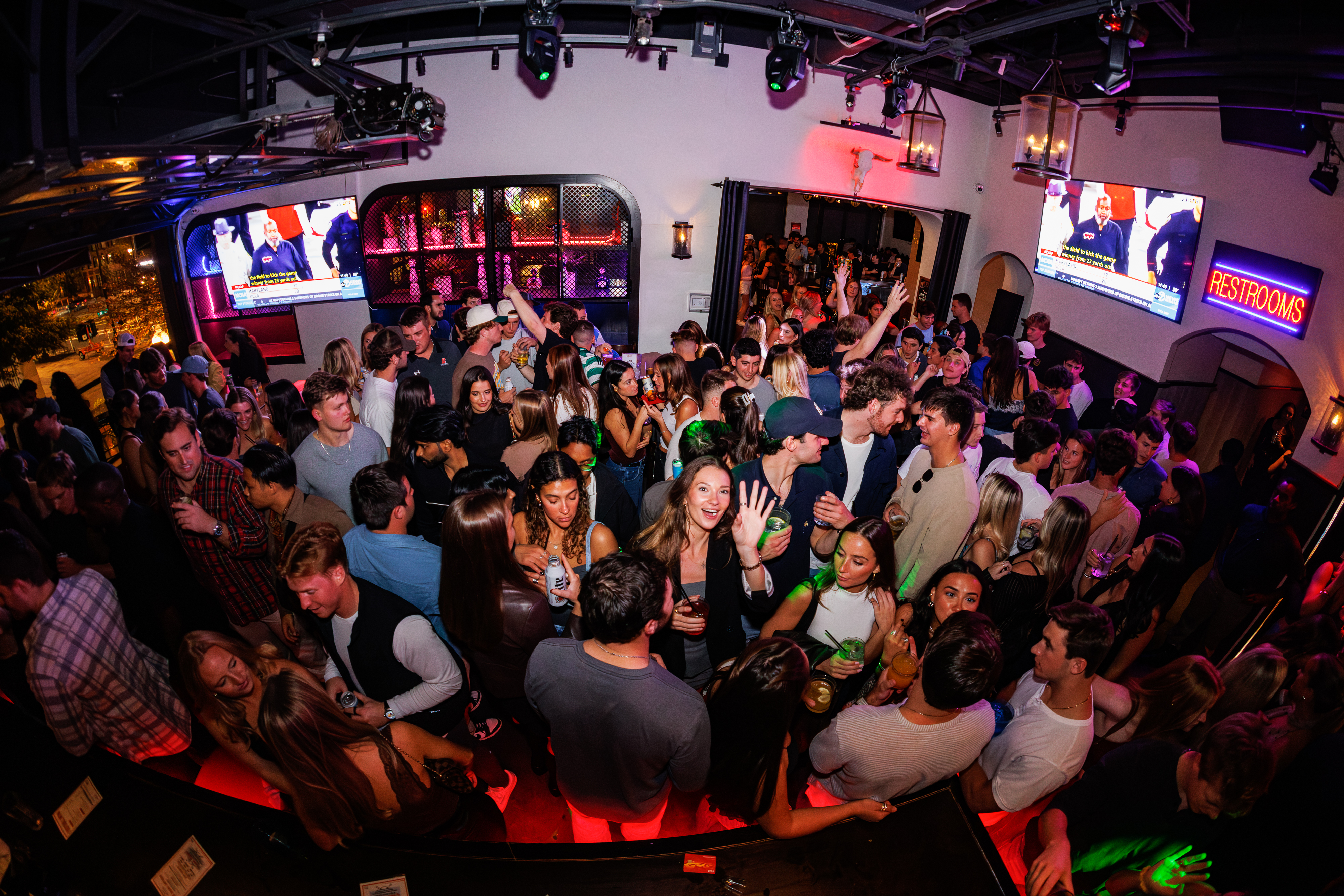 a group of people standing in front of a crowd posing for the camera