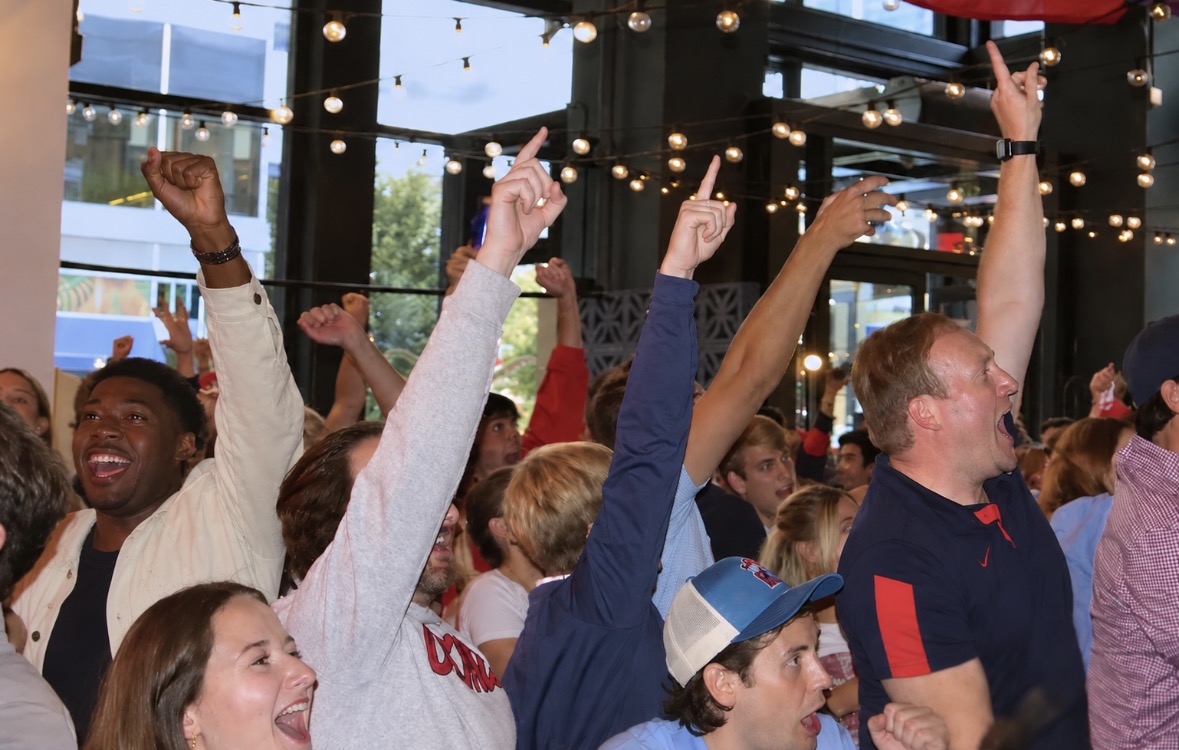 a group of people with their arms raised
