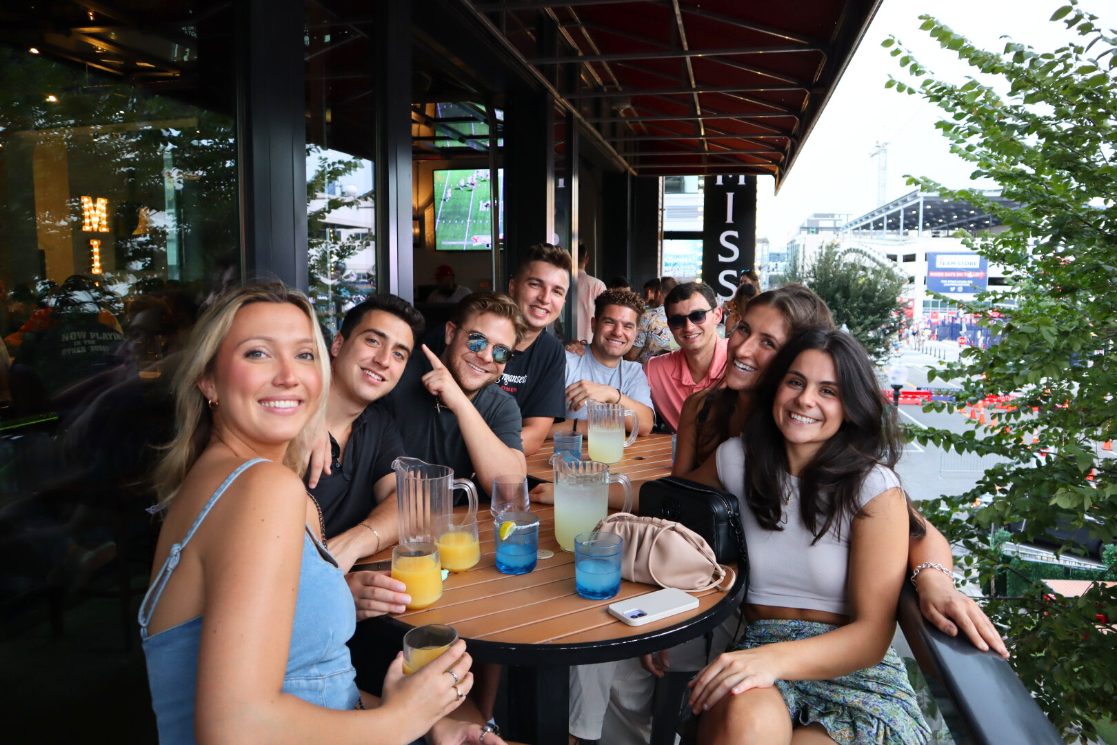 a group of people sitting at a table posing for the camera
