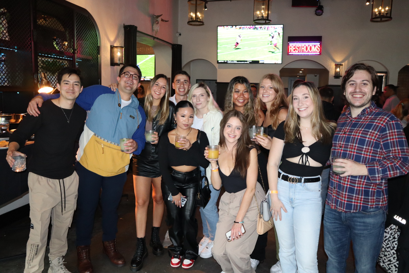 Eduardo Salvio et al. standing in front of a crowd posing for the camera
