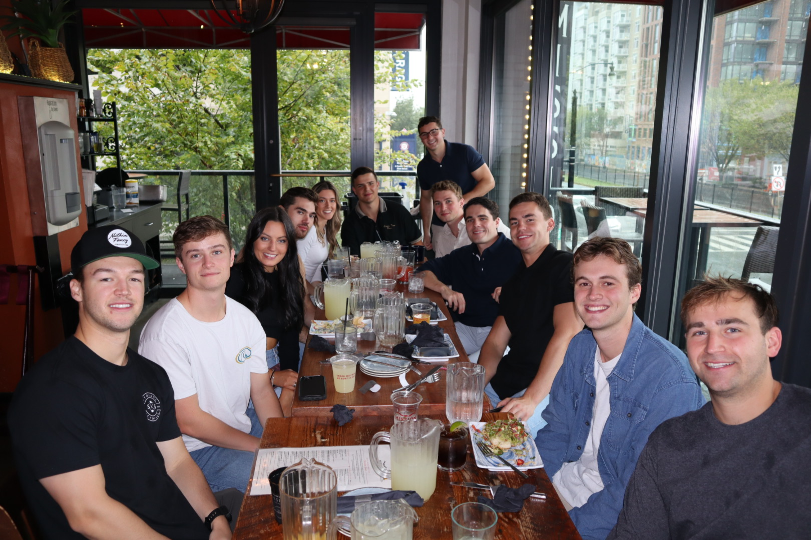 a group of people sitting at a table with wine glasses