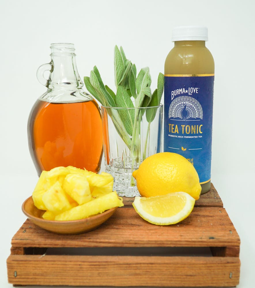 a glass of orange juice on a wooden table