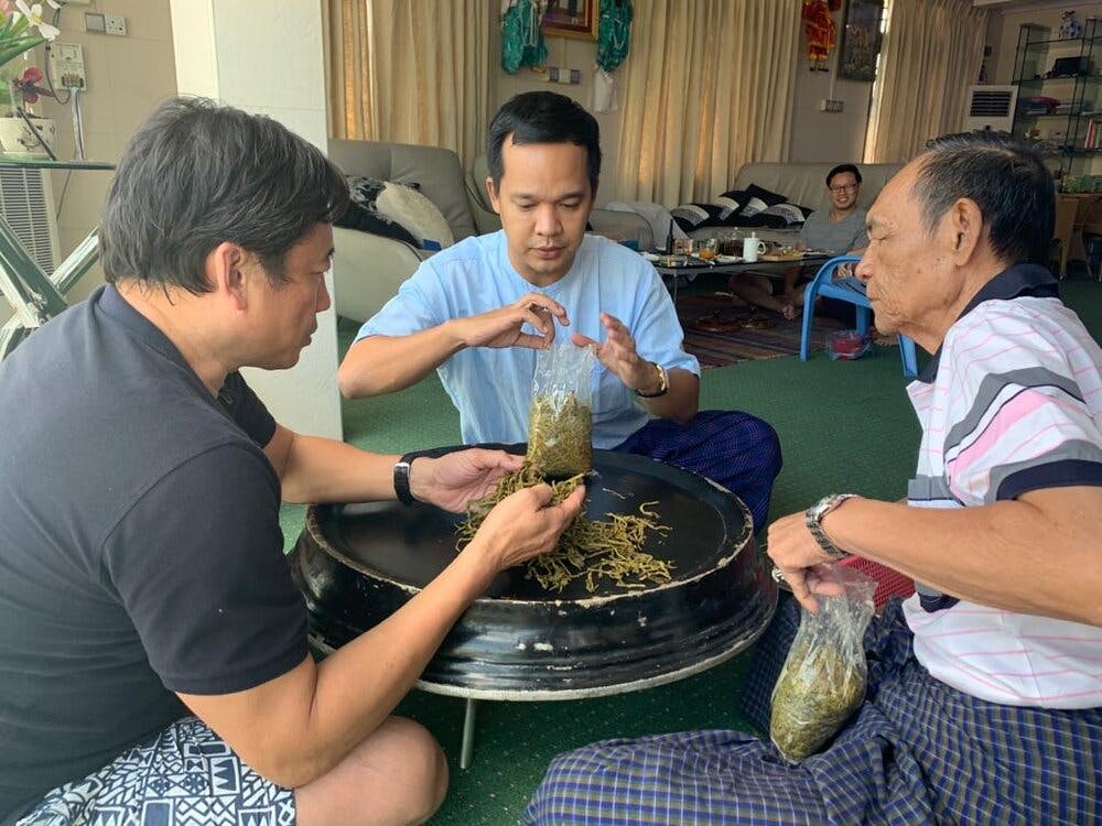 a man and woman cooking food in a bowl