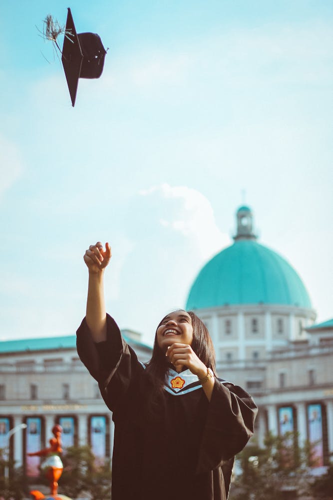 a person flying through the air while holding a cell phone