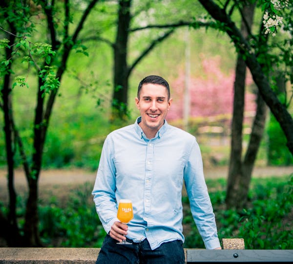 a man holding a frisbee in a park