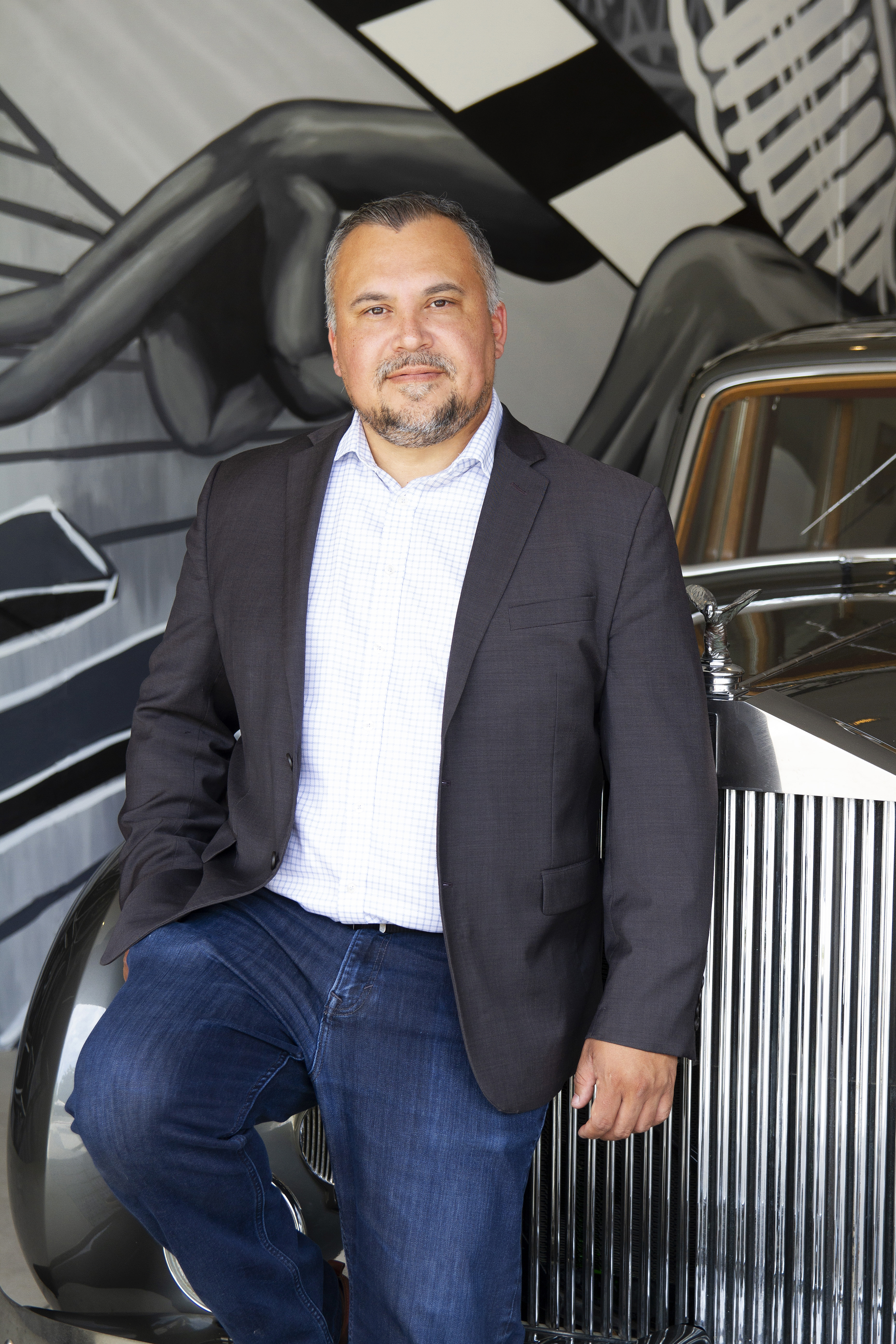 a man sitting in a chair talking on the phone