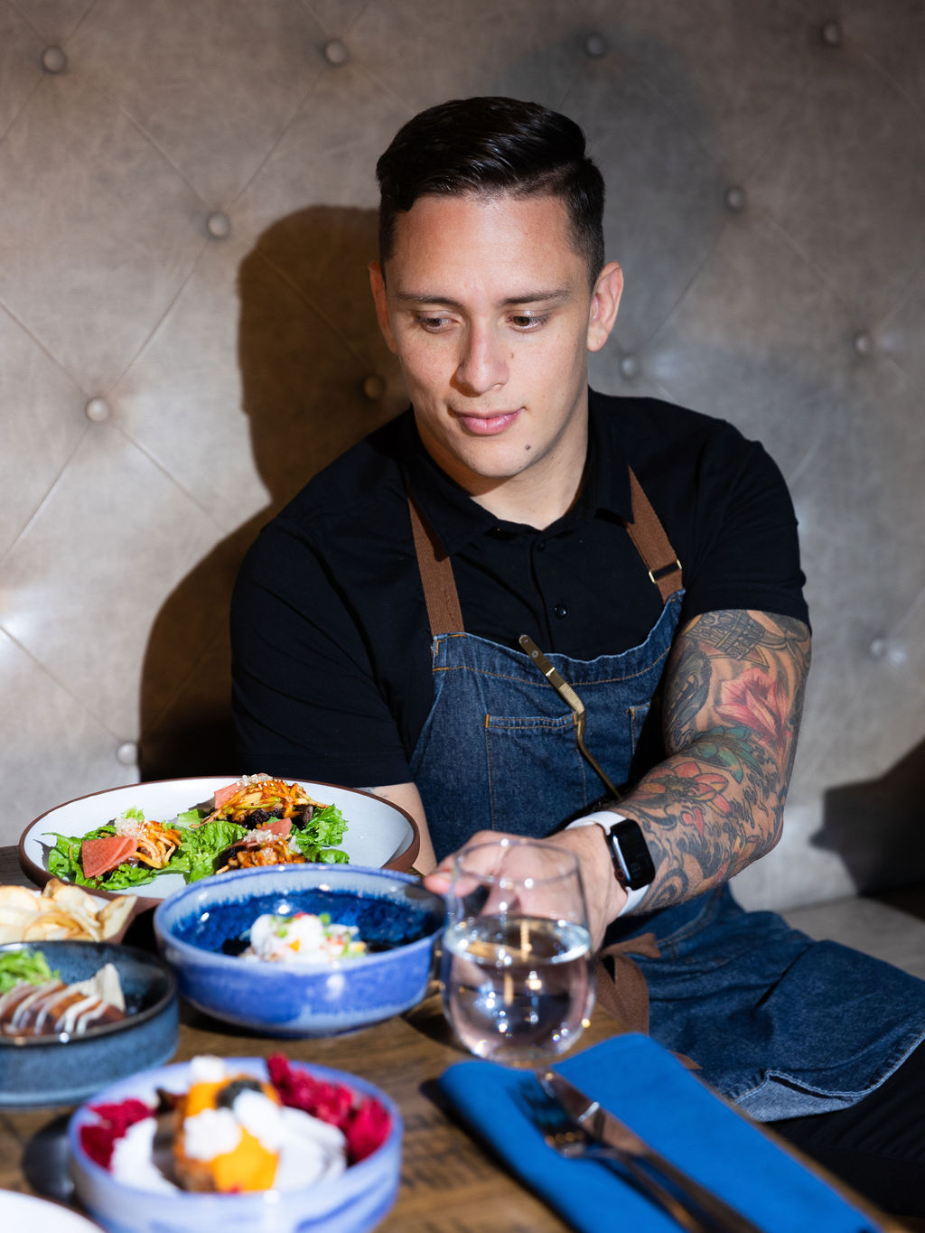 a person sitting at a table with a plate of food