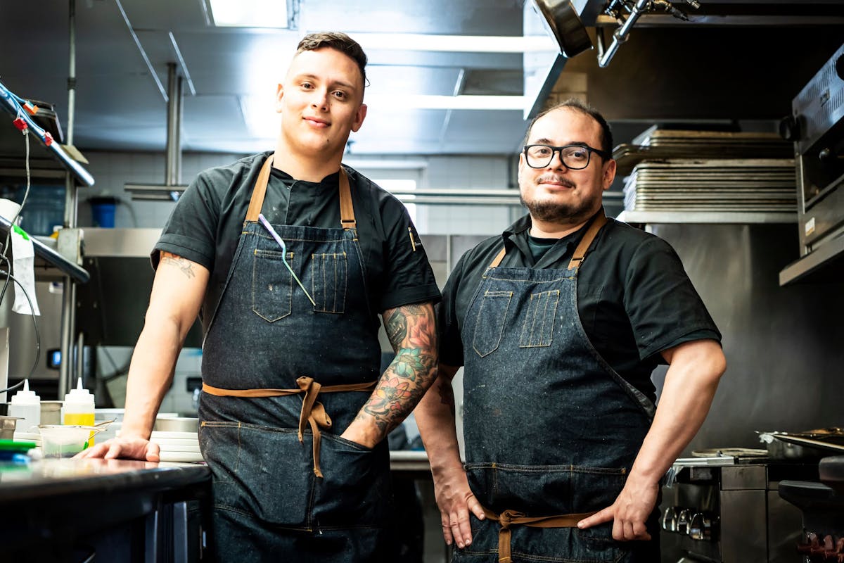 a man and a woman standing in a kitchen