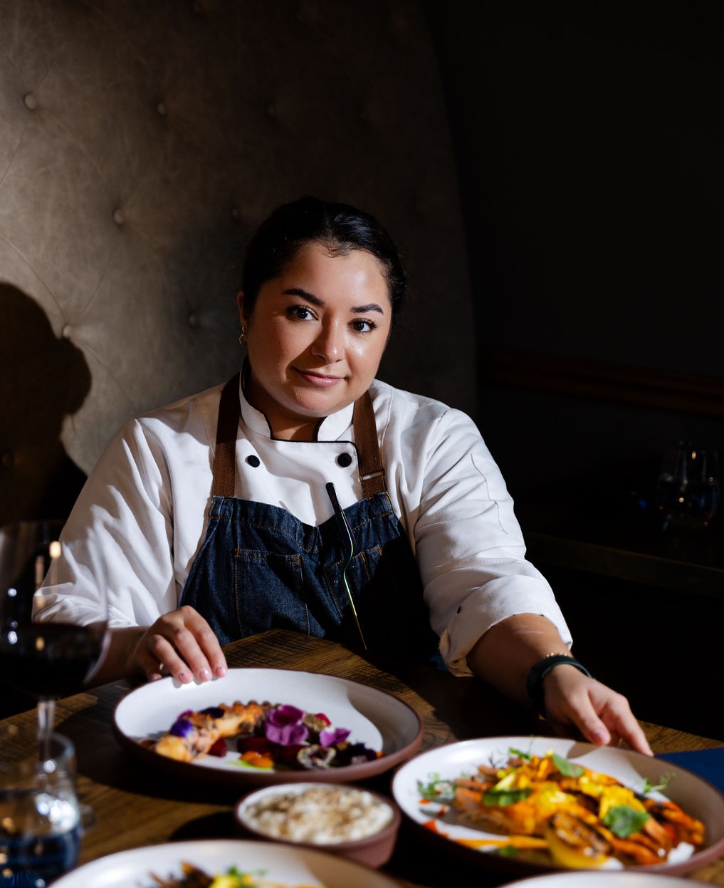 a person sitting at a table with a plate of food