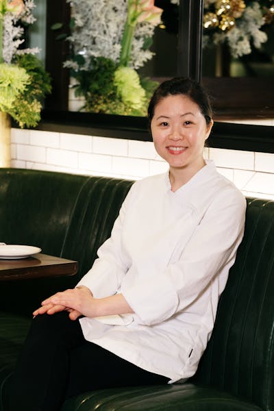 a person sitting on a bench posing for the camera
