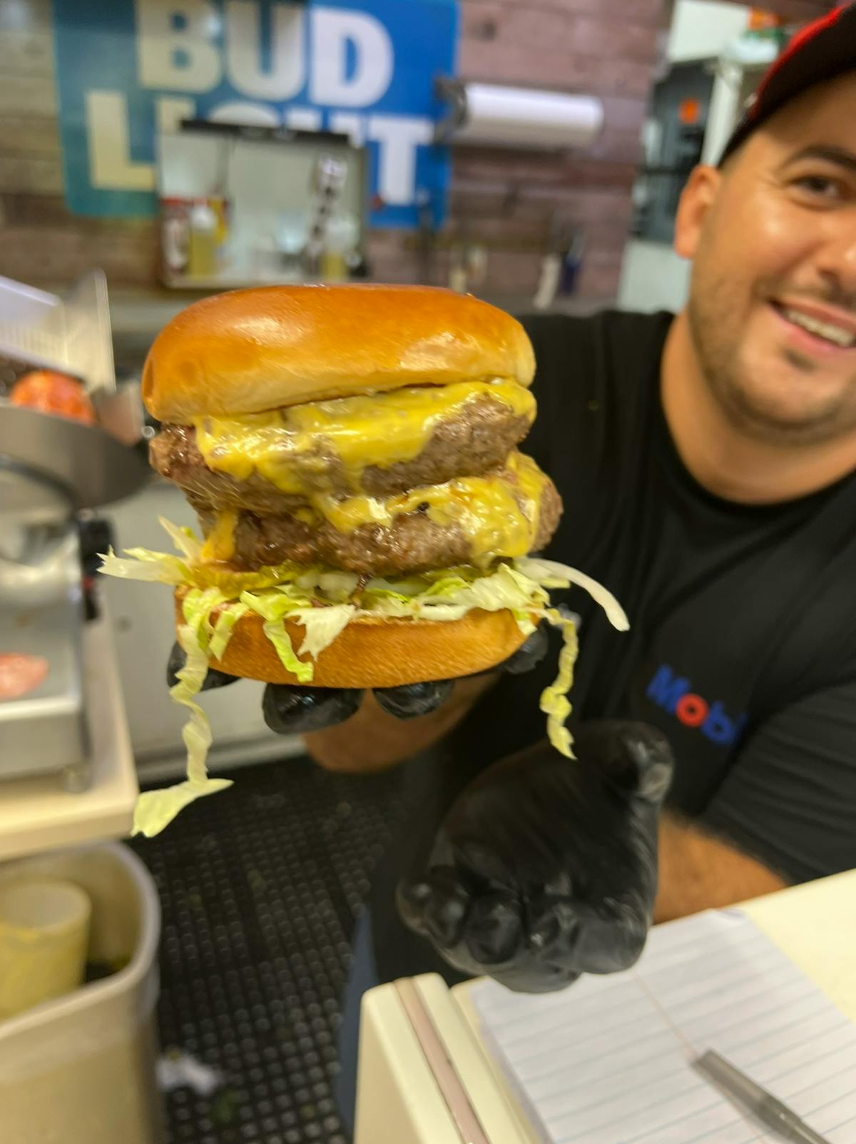 a person holding a sandwich in a restaurant