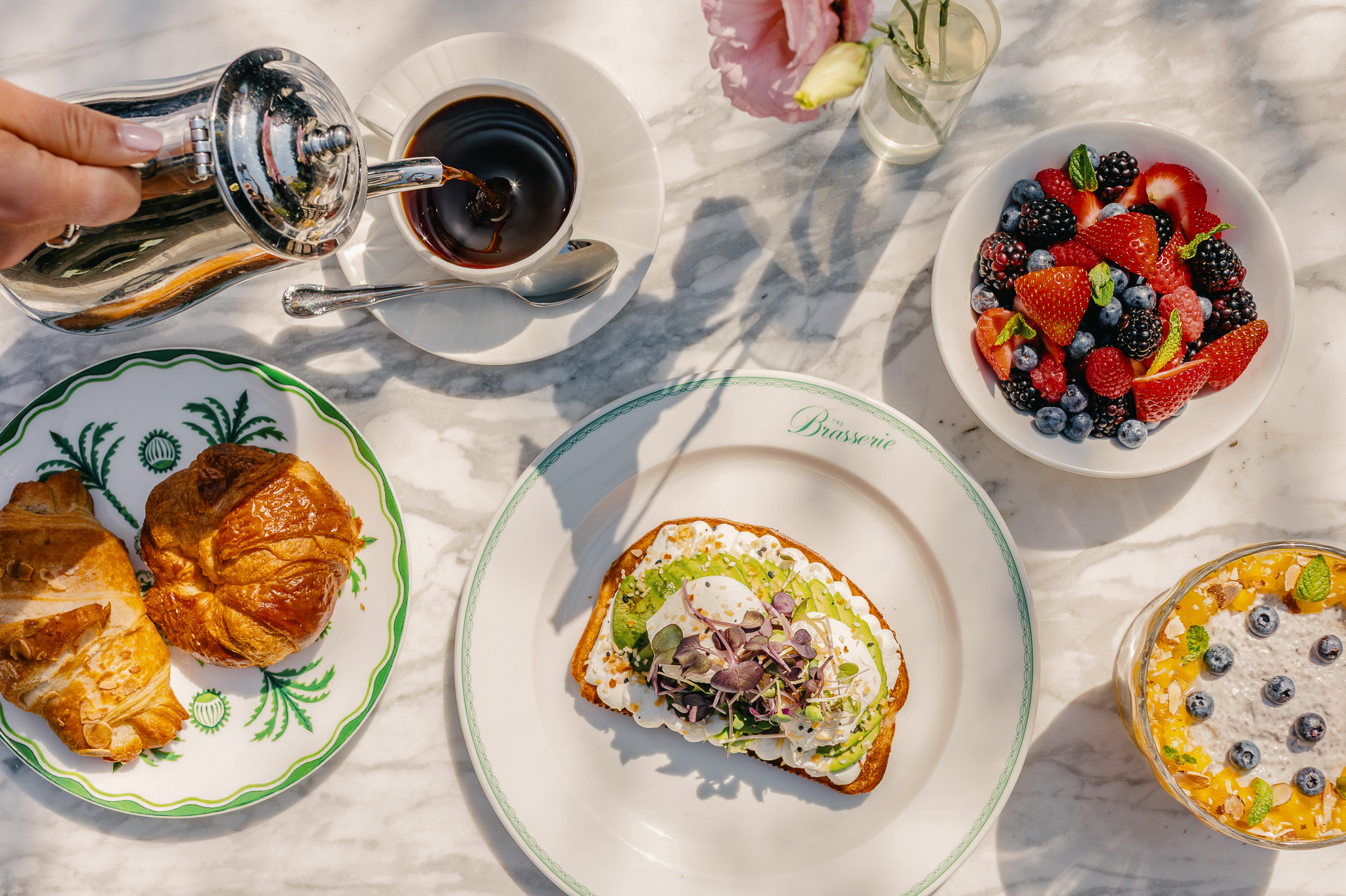 a table with plates of food and coffee