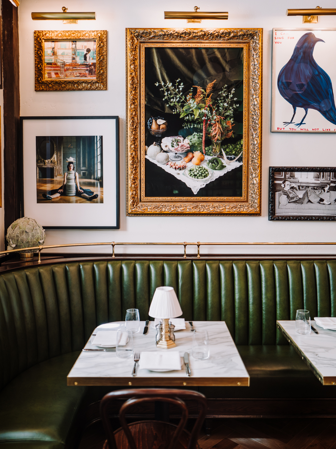 a table with a green booth and a lamp on it
