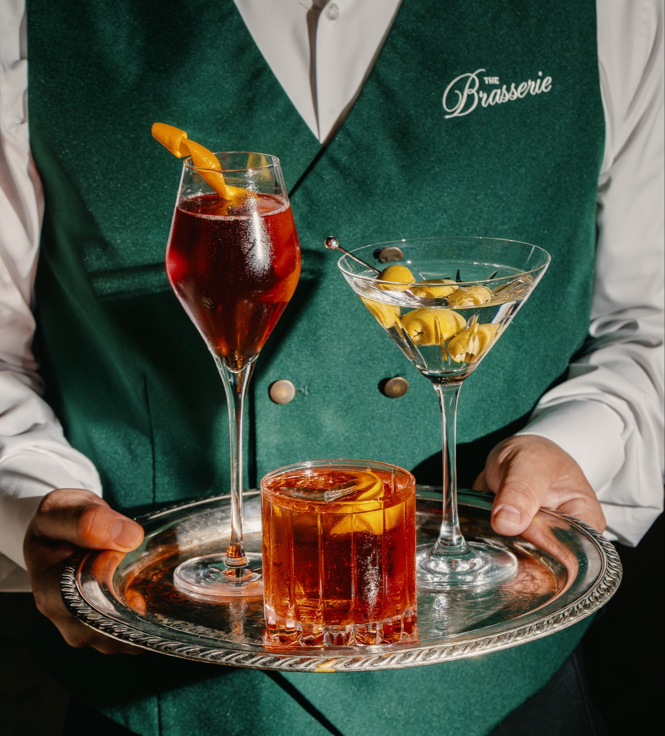 a person holding a tray with drinks
