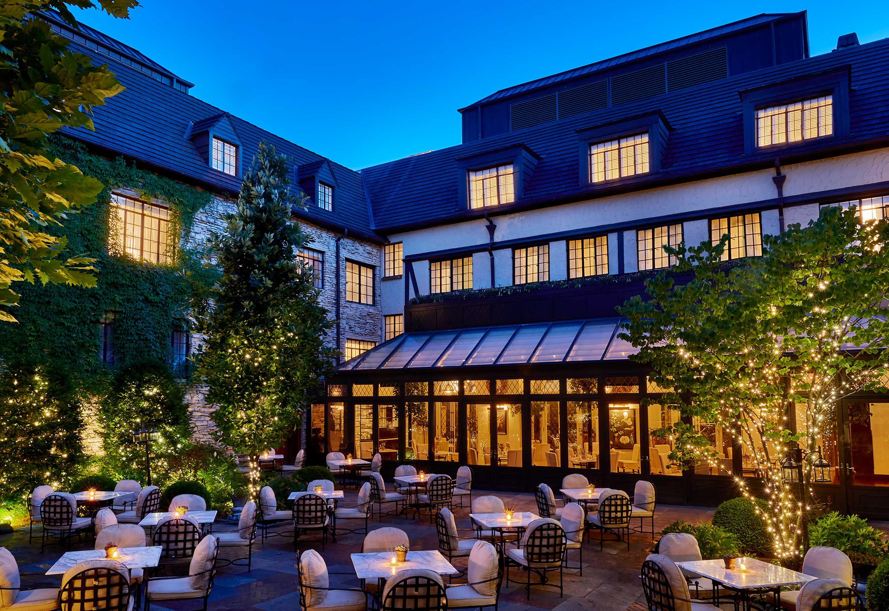 a courtyard of a building with tables and chairs