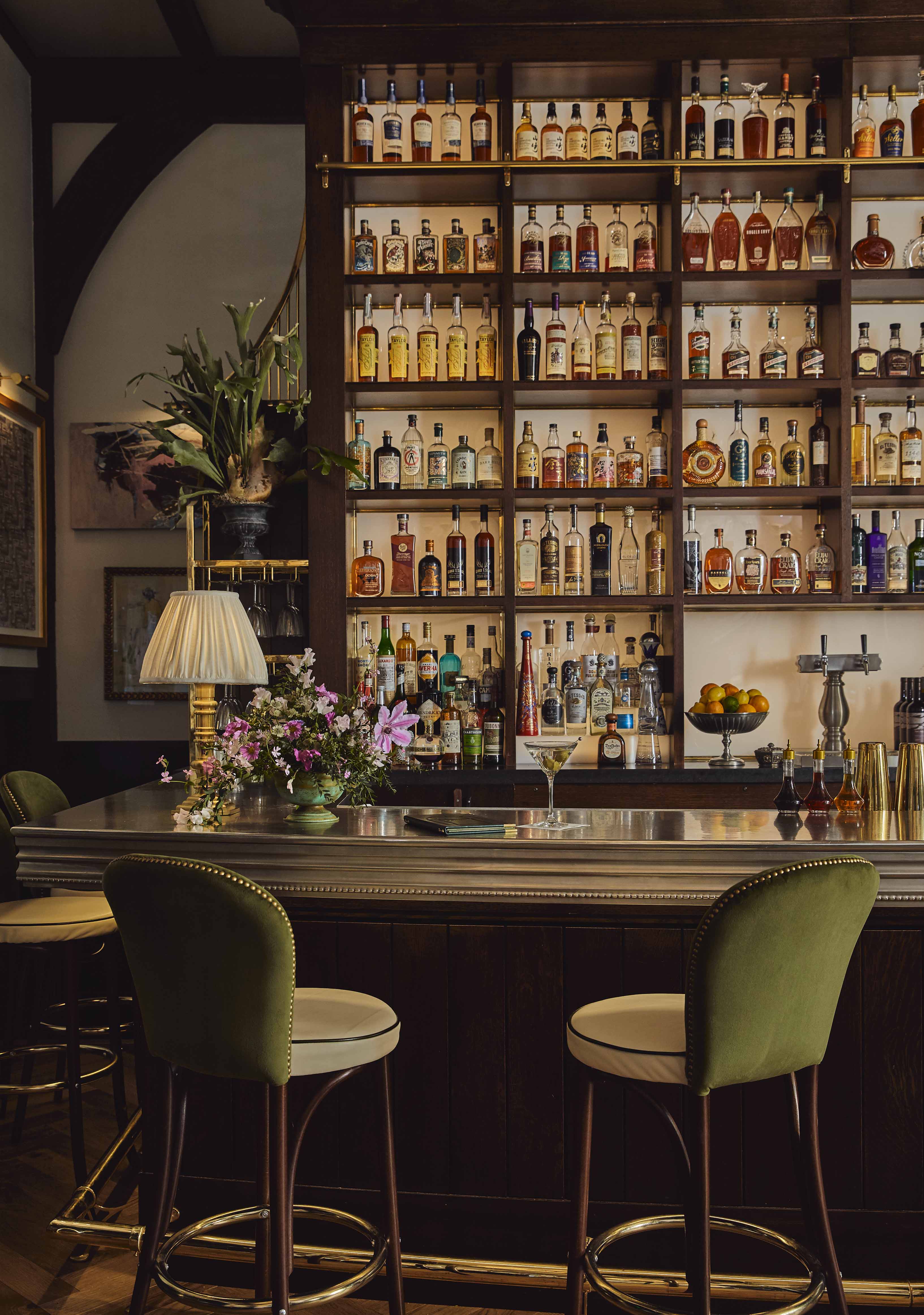 a bar with shelves of liquor bottles