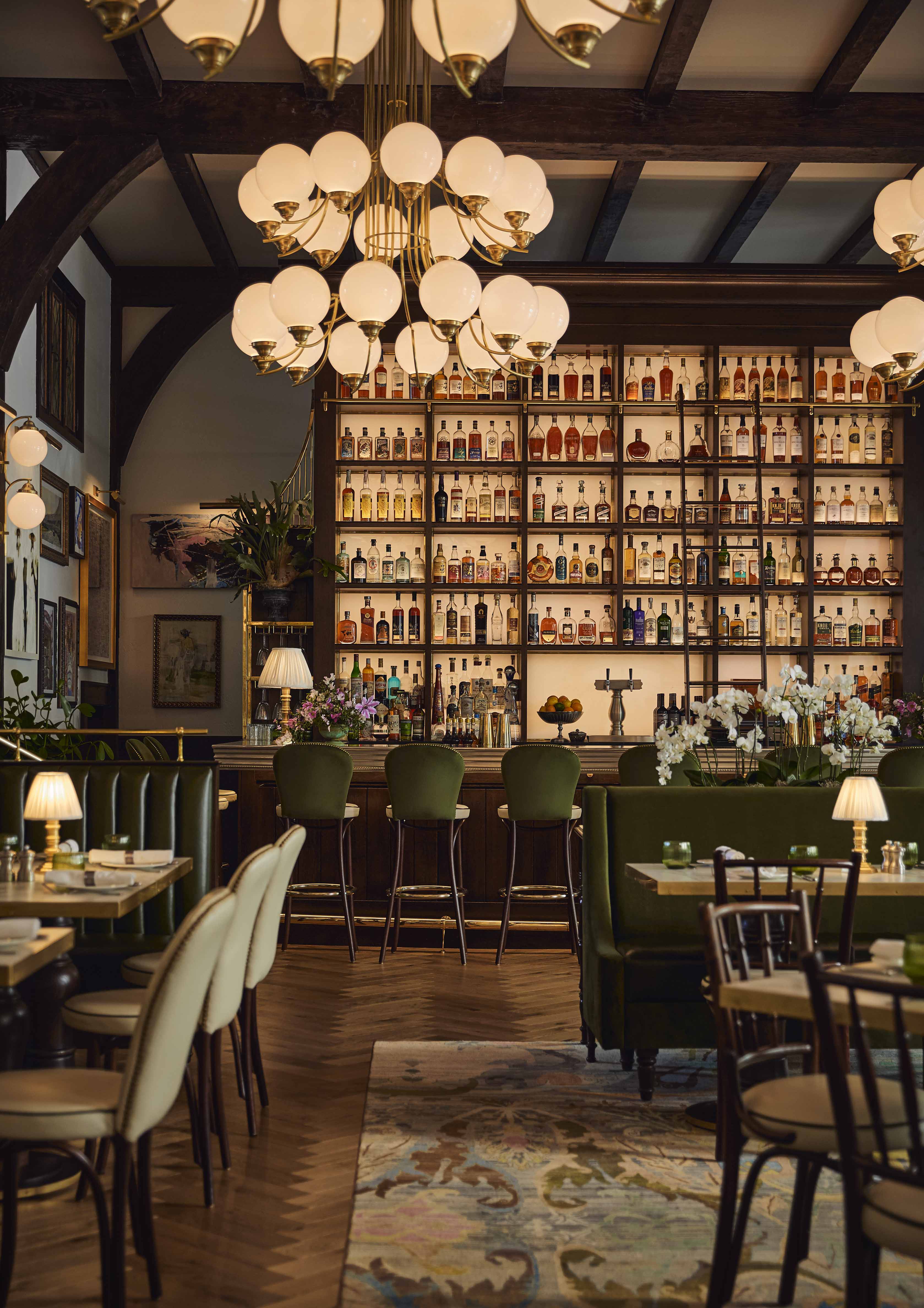 a restaurant with a bar and a chandelier