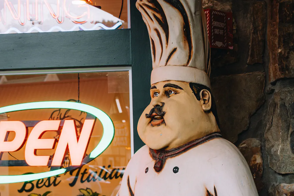 sculpture of a chef outside a restaurant