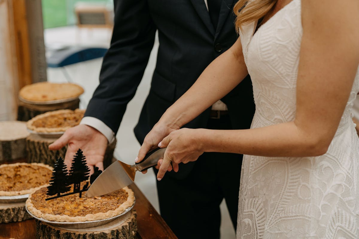 a woman cutting a cake