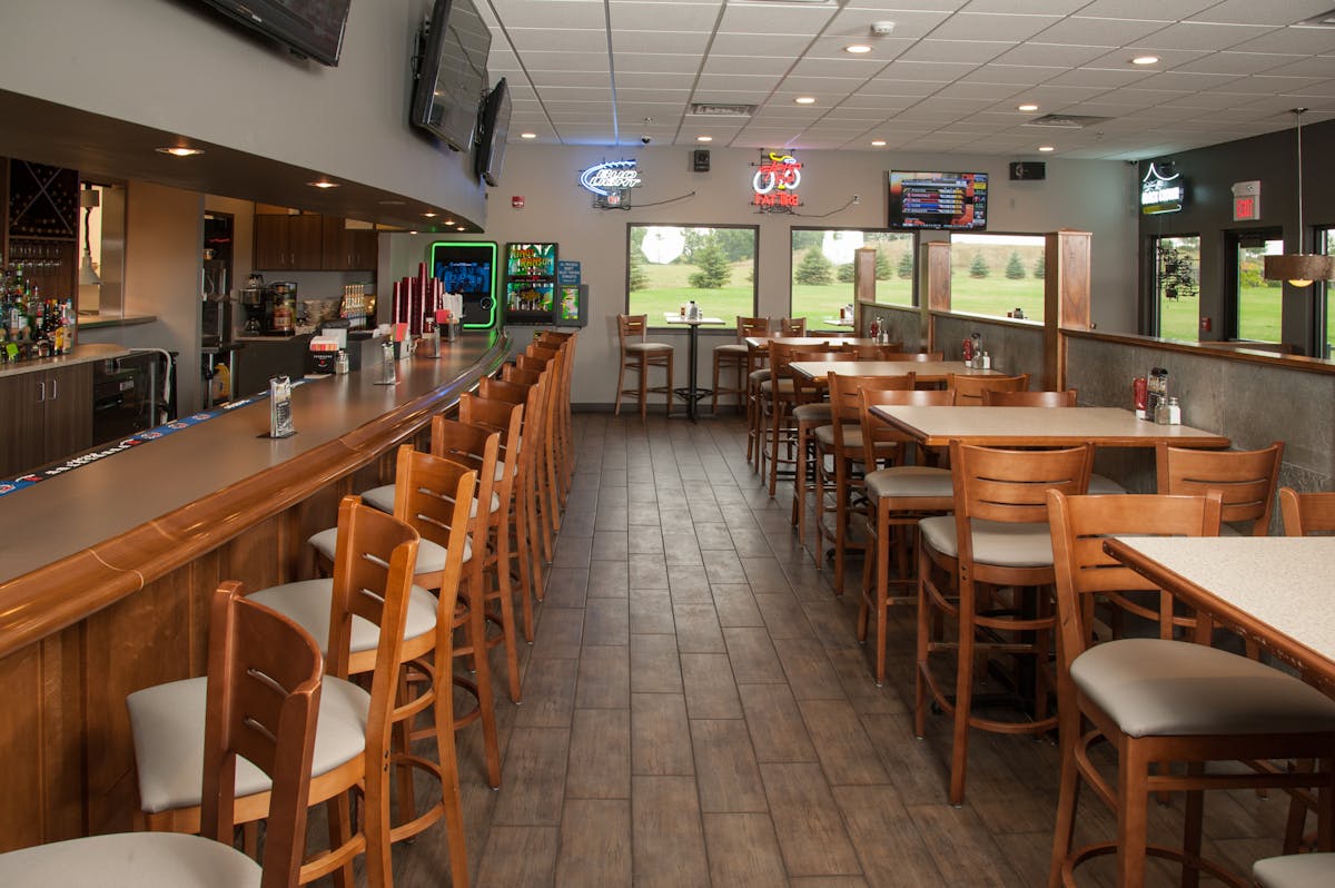 a big dining room filled with wooden tables and chairs