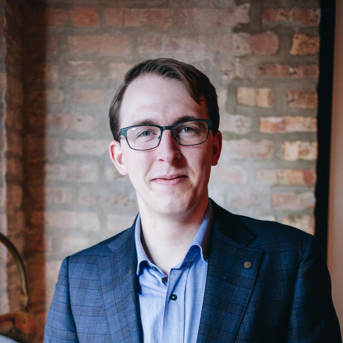 a man wearing a suit and glasses