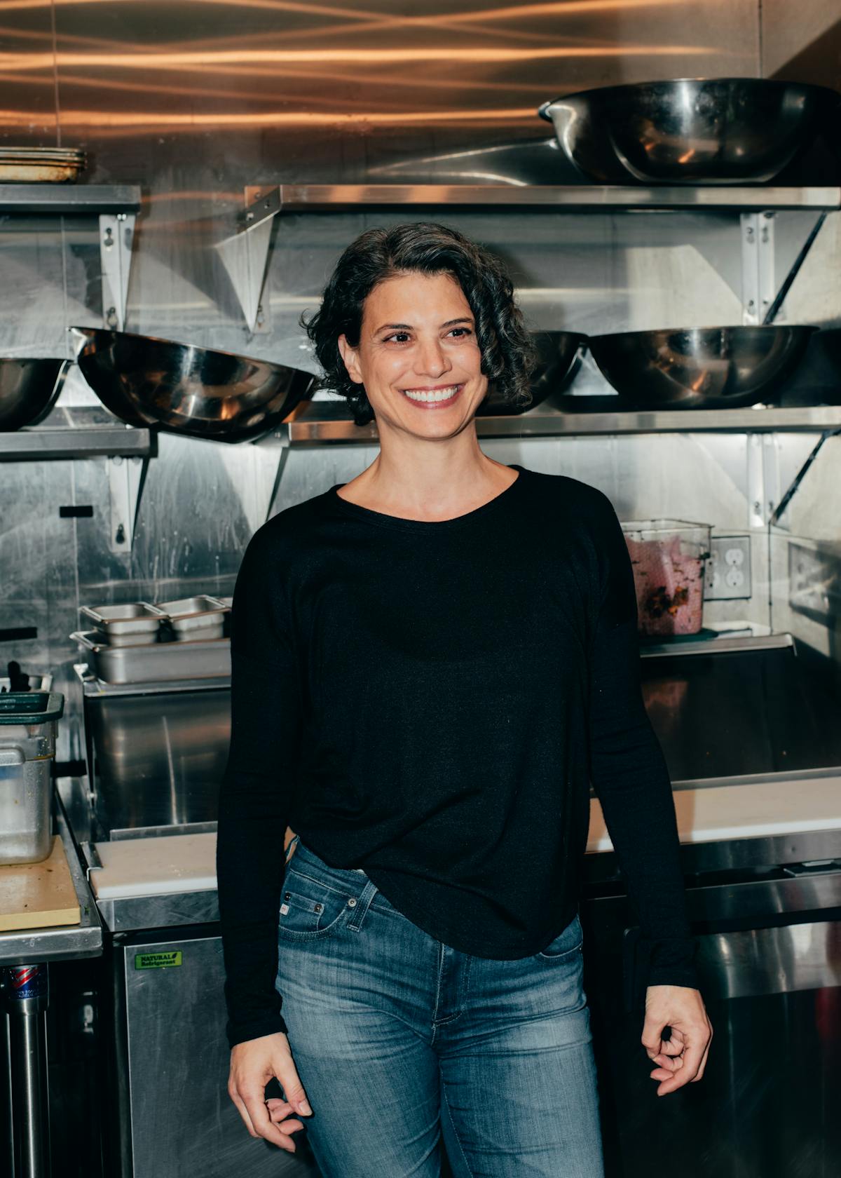 Elizabeth Meltz standing in a kitchen preparing food